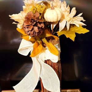 Artificial flowers in a wooden vase.